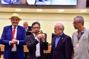 Pe. Djacy exibe sua medalha ao lado dos deputados Jeová Campos e Branco Mendes